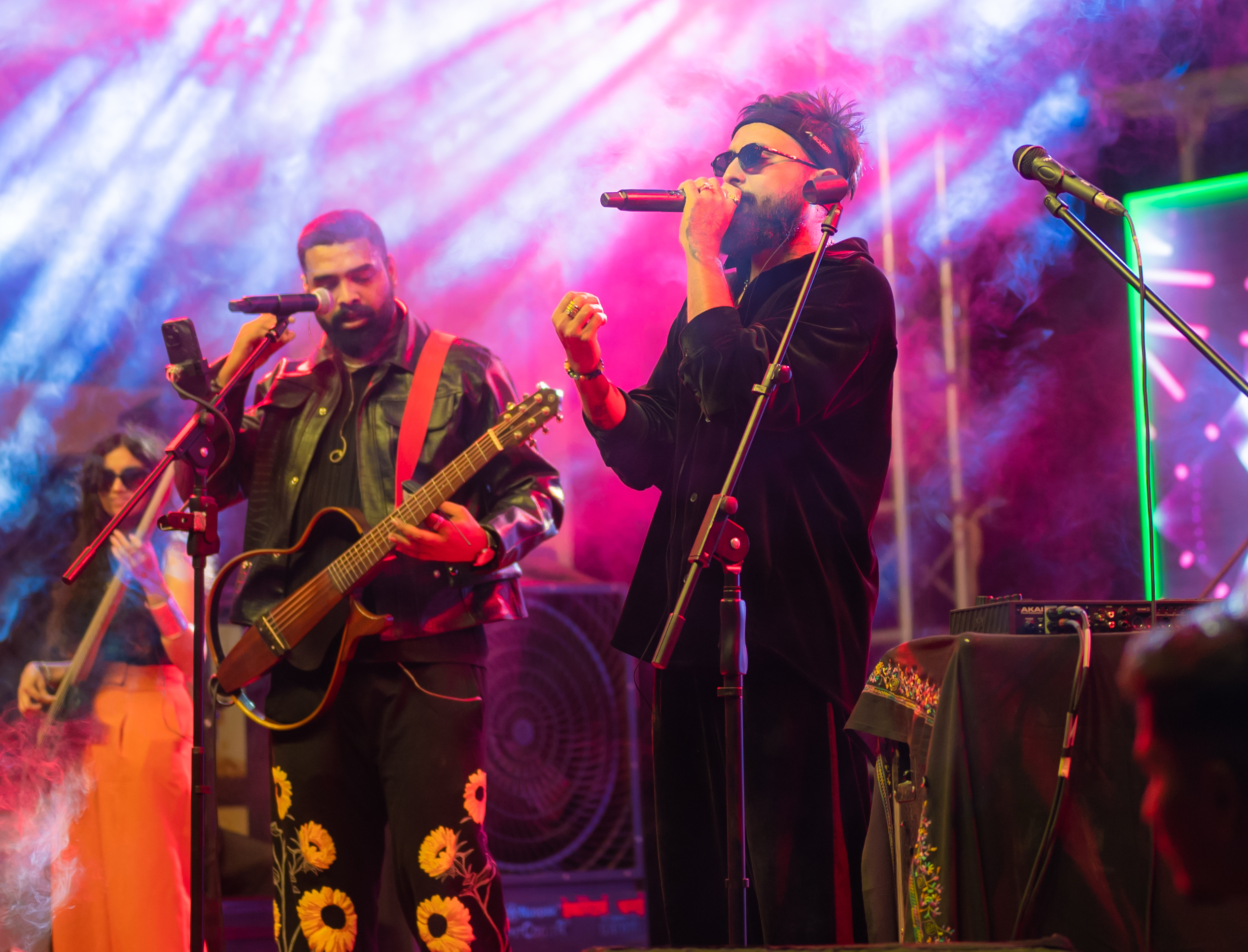 Sabali live on a festival stage with smoke and green lights